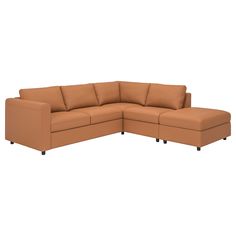 a brown sectional couch with two pillows on it