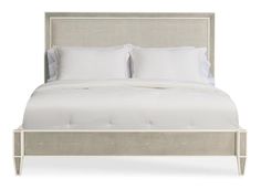 a bed with white linens and pillows on it's headboard, against a white background