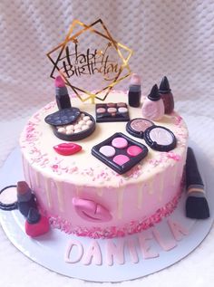 a birthday cake decorated with makeup and cosmetics