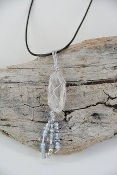 Clear Quartz Macrame Necklace This Clear Quartz point is wrapped with macrame thread & finished off with beads. Stone measures 1/2" wide x 1.5" tall. Black Cotton cord necklace adjusts from 19-21" with a lobster clasp & extender chain. Optional earrings have surgical steel ear wires, and clear quartz beads. Item# NG4868/4869 It is believed that clear quartz is a power stone. It has been called the universal crystal because of its many uses. It enhances energy by absorbing, storing, amplifying, balancing, focusing and transmitting. It channels universal energy. Because it directs and amplifies energy, it is extremely beneficial for manifesting, healing, meditation, protection, and channeling. Quartz is a stone of clarity which dispels negativity and clears away negative energy. It is used f Beaded Necklace With Adjustable Waxed Cord, Adjustable Macrame Crystal Necklace With Waxed Cord, Macrame Thread, Cotton Cord Necklace, Quartz Crystal Jewelry, Power Stone, Clear Quartz Point, Quartz Crystal Necklace, Protection Necklace