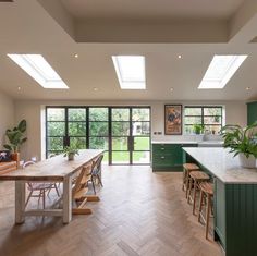 an open kitchen and dining room with skylights