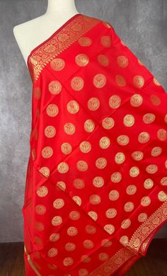 Gorgeous Bright Red Banarasi Dupatta. Dupatta is Soft and will add beauty to any Outfit. Makes a Perfect Gift! PLEASE NOTE - TASSLES AT THE ENDS OF THE DUPATTA ARE red IN COLOR. Item: DupattaColor : Bright RedFabric : Banarasi Silk (Non Pure Silk)Work : Zari Weaved with tassels Length of the dupatta : 35 inches (approx)Width of the dupatta : 92 inches (approx)Store Policies- No return or exchange will be accepted for color variations.- No return or exchange will be accepted if the color does not Banarasi Silk Dupatta With Latkans For Traditional Ceremonies, Red Traditional Wear With Zari Work For Festival, Red Dupatta In Traditional Drape For Celebration, Red Dupatta For Celebration With Traditional Drape, Elegant Red Dupatta With Motifs, Red Dupatta For Celebration In Traditional Drape, Traditional Red Dupatta For Celebration, Red Dupatta With Motifs For Puja, Red Dupatta With Traditional Patterns For Ceremonies