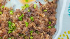 an egg and meat dish in a white bowl