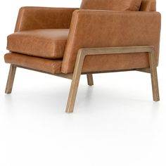 a brown leather chair with wooden legs and armrests on an isolated white background