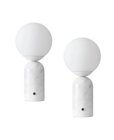 two white lamps sitting next to each other