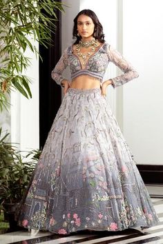 Grey ombre lehenga with architecture and gardenia depiction, needled with aari resham, multi-coloured sequins and cutdana. Comes with embroidered blouse.
Component: 2
Pattern: Hand Embroidered
Type Of Work: Architecture and Gardenia Motifs
Neckline: Plunged V-Neck
Sleeve Type: Long
Fabric: Butterfly Net
Color: Grey
Other Details: 
Tassel hem bouse
Back cut-out
Note: The outfit worn by the model on the back is not for sale
Occasion: Destination Wedding - Aza Fashions Grey Architecture, Ombre Lehenga, Pastel Lehenga, Grey Butterfly, Lehenga And Blouse, Butterfly Net, Desi Outfits, Neeta Lulla, Fabric Butterfly