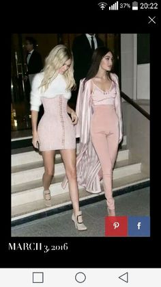 two women dressed in pink outfits walking down stairs together, one is wearing a white top and the other has blonde hair