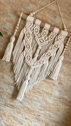 the wall hanging is made out of rope and wood