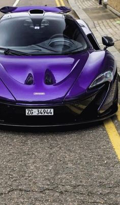 a purple sports car is parked on the street