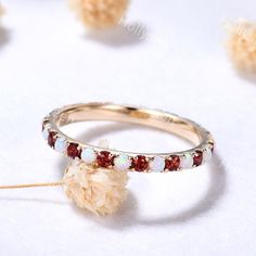 a ring with red and white stones on it