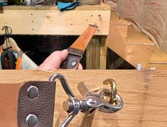 a person holding a pair of scissors in front of a piece of wood that is being worked on