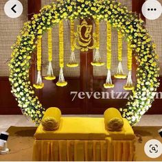 an arrangement of flowers and candles on display in front of a door with the words 7eventz written below it