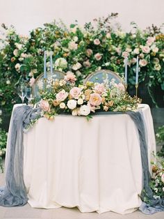 a table with flowers and candles on it