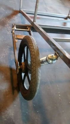 a wheelbarrow is sitting on the floor in an industrial area with no one around it