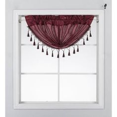 a window with a red curtain and tassels hanging from it's side