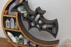 a wooden shelf filled with lots of different colored rocks and stones on top of it