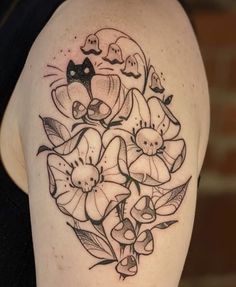 a black and white photo of flowers on the back of a woman's shoulder