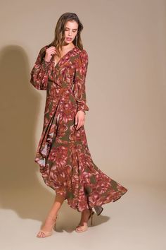 A printed woven maxi dress featuring surplice neckline, faux wrap with ruffled hemline and hi-lo, long sleeve with smocked cuff and side zipper closure Details: Self : 100% PolyesterLining : 100% Polyeste Size & Fit - Model is 5`8" And Wearing Size Small- Measurements Taken From Size Small- Approx. Length: Front - 39", Back - 59" Fall Maxi Wrap Dress For Brunch, Printed Maxi Dress For Brunch In Fall, Bohemian Maxi Dress With Asymmetrical Hem For Brunch, Flowy Midi Dress With Surplice Neckline For Fall, Chic Maxi Dress With Ruffle Hem And Surplice Neckline, Chic Maxi Dress With Surplice Neckline And Ruffle Hem, Fall Maxi Dress With Ruffle Hem And V-neck, Green Ruffle Hem Maxi Dress For Fall, Floral Print Wrap Dress With Surplice Neckline For Fall