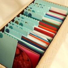 an open box containing many different colored folders