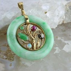 Vintage 14K Yellow Gold Jadeite Sapphire Ruby and Opal Pendant, star ruby black star sapphire jade and opal crystal cabochons, central decoration enclosed in a green and white jade ring, gold dial suspension, Circa 1950, 1 3/8 inches across, .5 inch bail, 14.3 grams Stock # BB191P24 This listing contains photographs of the actual item you will receive. Our items are in excellent condition with little or no signs of wear and many are one of a kind pre-owned estate finds. Please look closely at th Black Star Sapphire, Star Sapphire, Jade Ring, White Jade, Star Ruby, Fine Jewelry Designers, Yellow Gold Earring, Opal Crystal, Opal Pendants