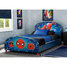 a child's bedroom with blue walls and spiderman bedding