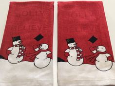 two red towels with snowmen on them