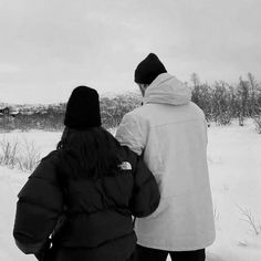 two people are walking in the snow together