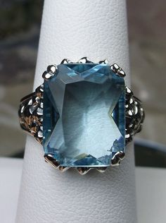 <> #144 {Made To Order} Inspired by Gothic designs, I now offer this lovely filigree inspiration in sterling silver. This is a flawless Man-made/simulated aquamarine is 15mm (5/8th of an inch) by 12mm (1/2 inch) in size. The inside of the band is etched 925. Notice the intricate and detailed Victorian design of the antique patina silver filigree setting all the way down the band. This is an exquisite rendition of an antique filigree ring.... and is ready to wear. A gift-box is included for Antique Filigree, Order Design, Gothic Design, Victorian Design, Aquamarine Rings, Filigree Ring, Victorian Jewelry, Aquamarine Blue, Silver Filigree