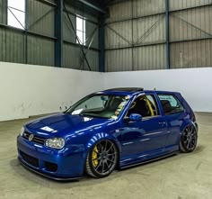 a blue car is parked in a garage