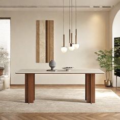 a modern dining room with white walls and wood flooring, an art piece hanging from the ceiling