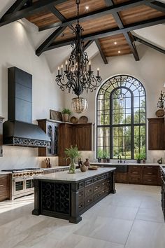 a large kitchen with an island and chandelier