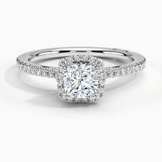 a cushion cut diamond engagement ring with pave set shoulders