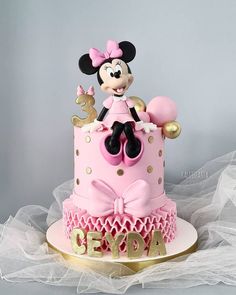 a pink and gold minnie mouse birthday cake