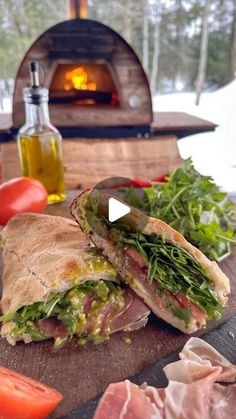 a sandwich cut in half sitting on top of a cutting board