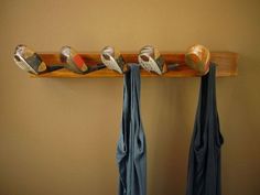 four pairs of shoes are hanging on a coat rack