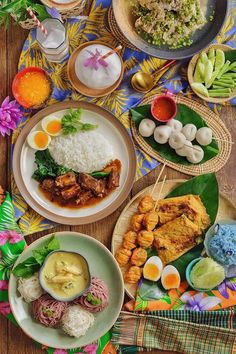 a table topped with plates and bowls filled with different types of food on top of it