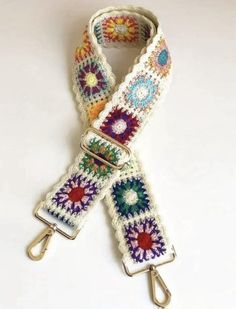 a white crocheted belt with multicolored flowers on it