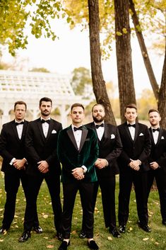 Group of Groomsmen and Groom standing in v formation, groom with velvet green jacket, skinny pants, and loafers. Black Green Groomsmen Attire, Black And Emerald Groomsmen, Black And Green Wedding Groomsmen, Groomsmen Attire Black And Green, Emerald Green Groomsmen Attire Groom & Groomsmen Suits, Mens Wedding Attire, Groom Wedding Attire, Minneapolis Wedding, Wedding Day Timeline