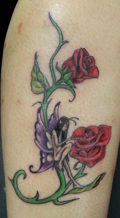 a tattoo on the leg of a woman with three roses and a lady in a dress