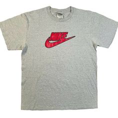 Vintage early 2000s Nike tee, gray with black and red swoosh and spell out on front center of chest.  Men's large, please see measurements below. 28" length 20" width 90s Sports T-shirt For Summer, Y2k Gray T-shirt For Streetwear, 90s Summer Sports T-shirt, Sporty Heather Grey T-shirt For Sports, Gray Y2k Style Summer T-shirt, Nike Graphic Print T-shirt In Athletic Heather, Gray Logo Print Sports T-shirt, Gray Sports T-shirt With Logo Print, Athletic Heather T-shirt With Letter Print For Streetwear