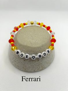 Support your favourite team with these "Box Box" Formula One friendship bracelets. Dimensions: Diameter: ~6cm String length: ~20cm Teams: Red Bull Racing: Blue, Red & Yellow Ferrari: Red, Yellow & White McLaren: Orange & Black Mercedes: Turquoise, Black & Silver Trendy Rectangular Beaded Bracelets For Gifts, Trendy Rectangular Beaded Bracelets As Gift, Red Name Bracelet With Letter Beads For Gift, Formula One Bracelet, F1 Friendship Bracelet, Ferrari Bracelet, F1 Bracelet, Team Friendship, White Mclaren