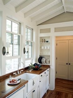 the kitchen is clean and ready to be used for cooking or baking, as well as dishes on the counter