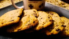 chocolate chip cookies next to a cup of coffee