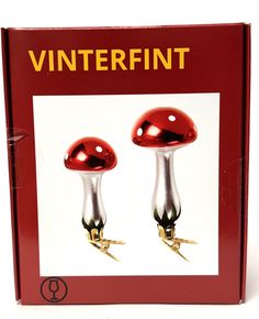 a red box with two shiny metal knobs on each side and the words vinterfint written in gold