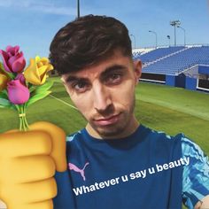 a man holding a flower in front of his face with the caption whatever u say beauty