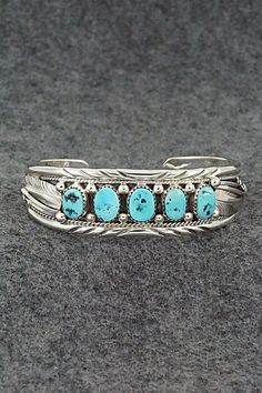 This turquoise and sterling silver bracelet was made by Navajo silversmith Davey Morgan. The back is signed D and stamped sterling.Size: 5 3/4" (will fit up to a 6 5/8" wrist)Gap: 7/8"Width: 3/4"Free shipping on all orders! We ship with USPS and always include tracking. All orders ship within a day of payment.Returns are accepted up to 30 days after you receive your order. Just send us a message. Our shop offers cash back or store credit. The item must be returned in new condition. Sterling Silver Bracelet, Turquoise Sterling Silver, Sterling Silver Bracelets, Silver Bracelet, Jewelry Watches, Gap, Stamp, Turquoise, Bracelet