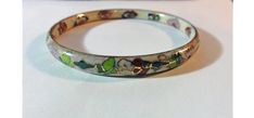 "Enamel on brass cloisonné' bangle bracelet with floral design. - pink, yellow, red, green, blue flowers and leaf on the outside and inside - off white background with shiny golden brass accents - measurements - 9 1/2\" outside circumference - 1/4\" wide - 2 3/4\" across - hallmark - none - condition - no issues. Clean with no noticeable chips or fading." Hand Painted Multicolor Bangle Jewelry, Multicolor Enamel Bangle Bracelets, Multicolor Hand Painted Bangle Jewelry, Vintage Multicolor Enamel Bangle, Bohemian Enamel Bangle Bracelet, Bohemian Enamel Bangle Bracelets, Green Enamel Bangle, Handmade Enamel Bangle, Hand Painted Multicolor Bangle