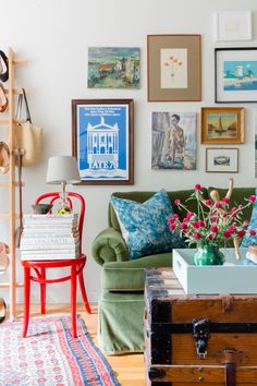 a living room filled with furniture and pictures on the wall