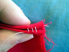 someone is stitching the end of a red piece of fabric