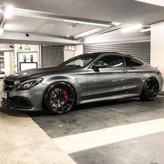 a silver car is parked in a garage